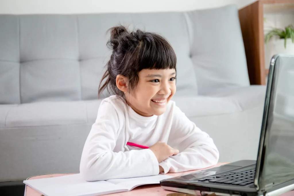 female student with bangs smiling during online class
