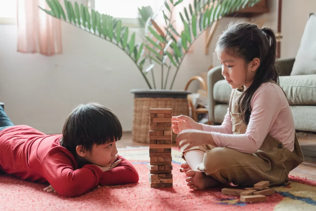 boy and girl playing with wooden bricks
