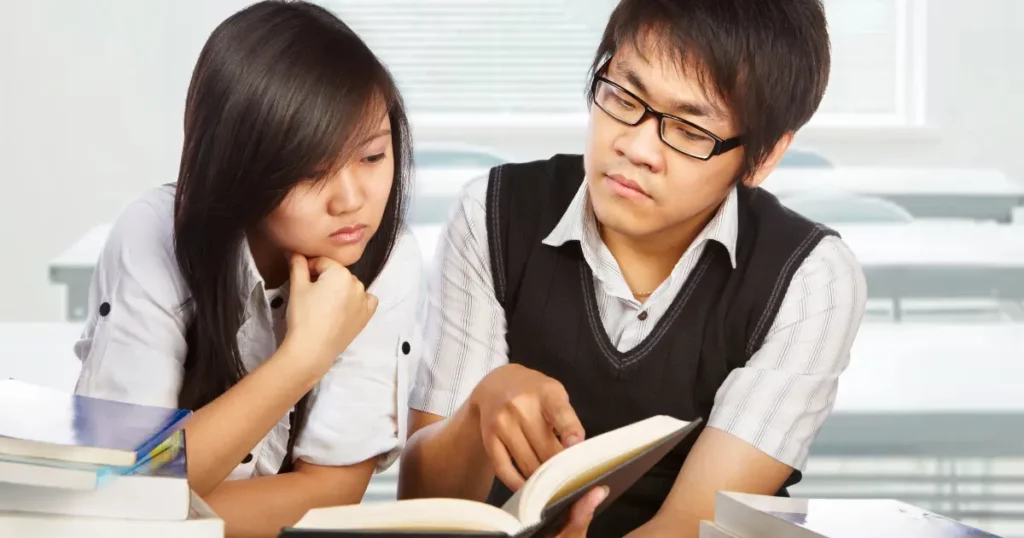 tutor teaching young student to read