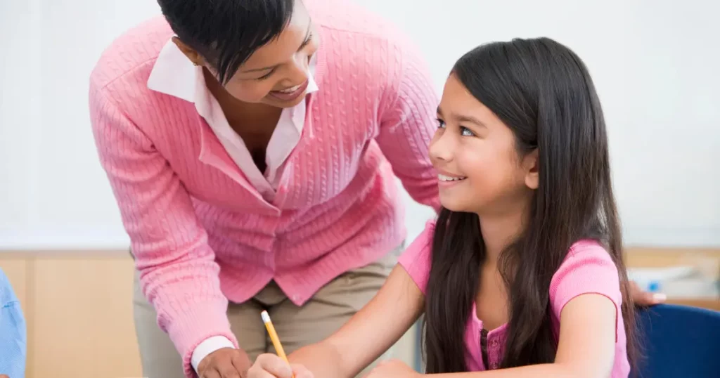 full-time tutor helping young girl in written activity