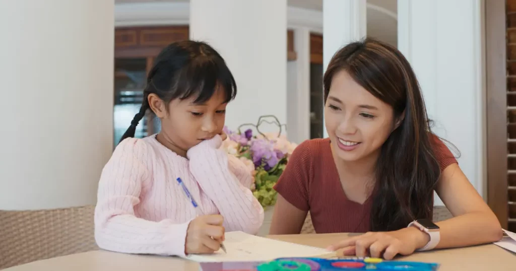 woman teaching little girl to draw